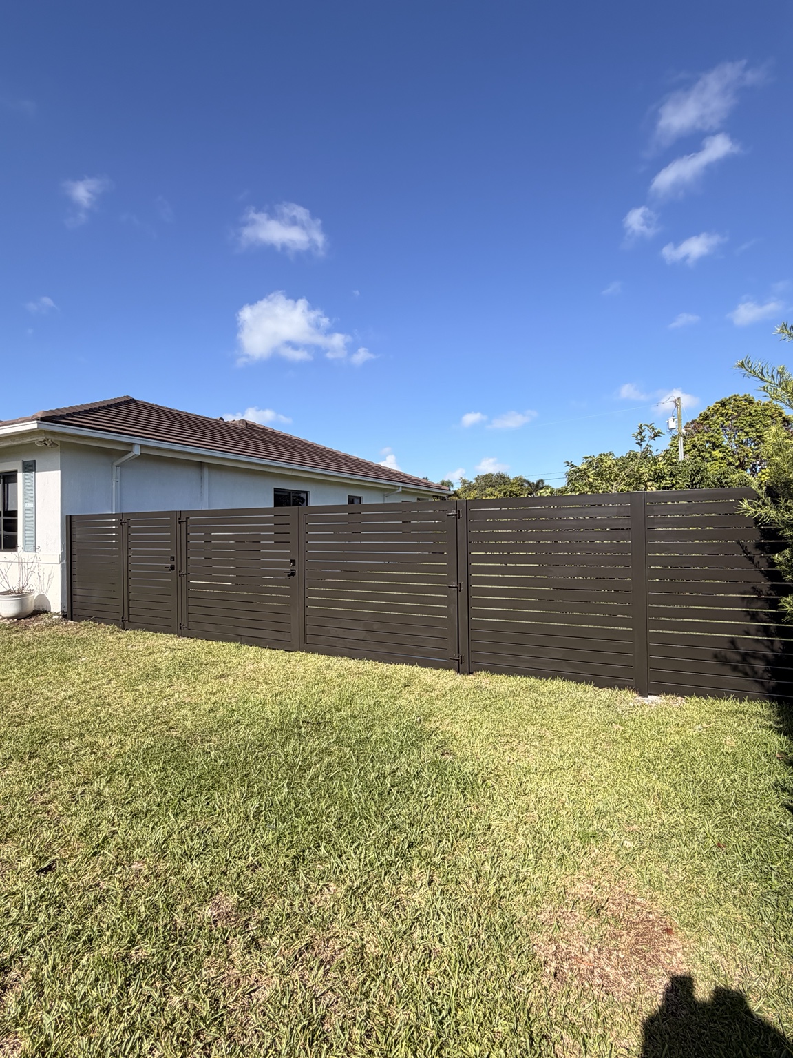 Residential horizontal slat fence and gates