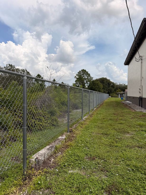 Galvanized chain-link fence running along a property line