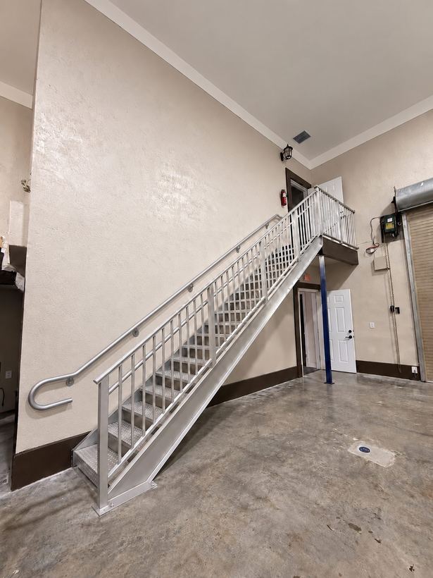 Aluminum commercial staircase with picket guardrail seen from the floor